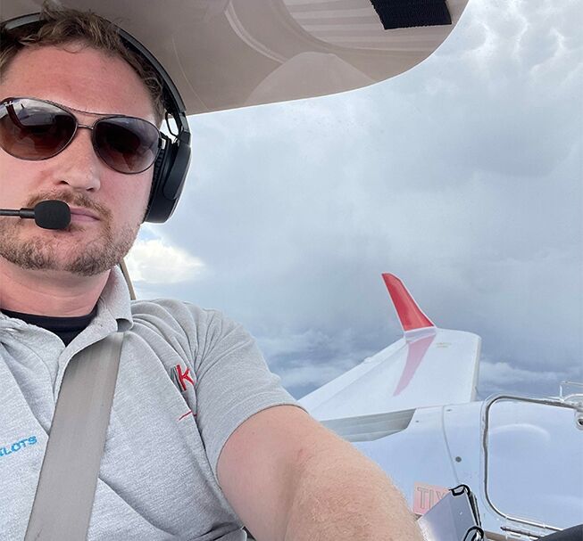 Selfie of pilot in cockpit while flying