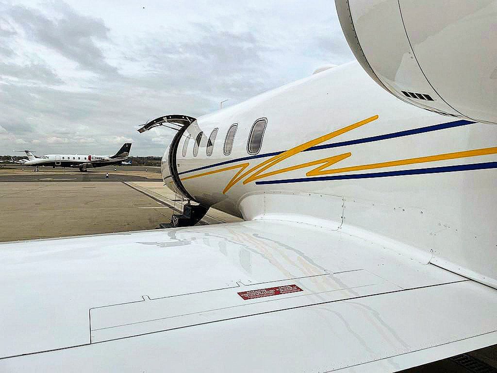 Close up of wing of airplane with opened hatch