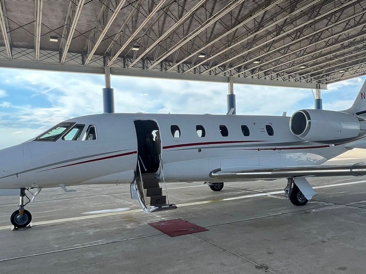 airplane on a runway with open gangway