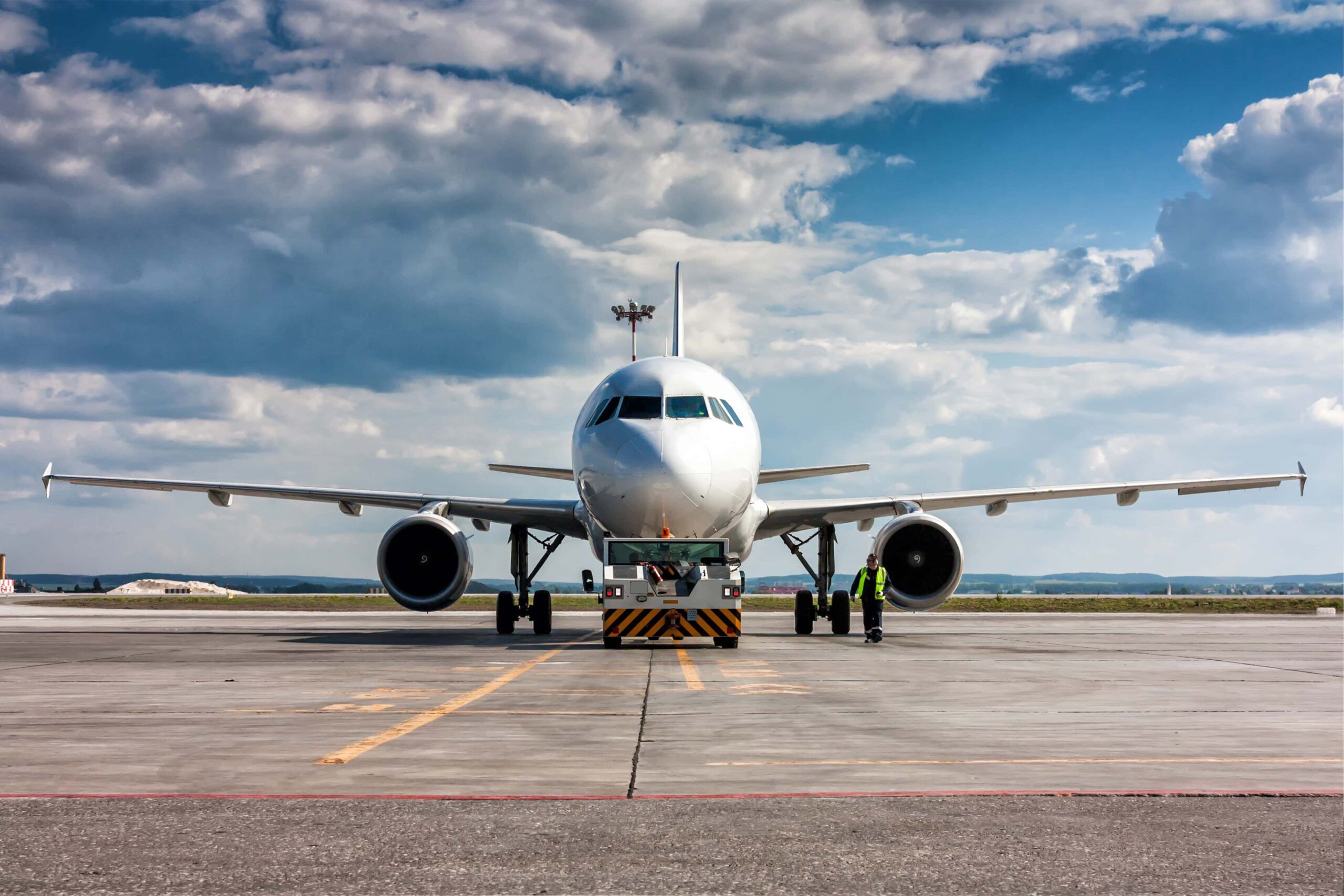 Aircraft tug tows the plane to a car park