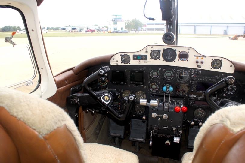 Cockpit view of Aero Commander 500 N711NE with analog flight instruments and dual yokes