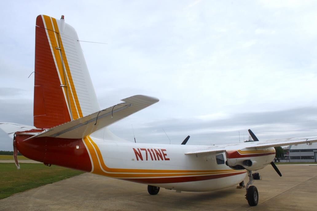 Rear view of Aero Commander 500 N711NE showing tail and vertical stabilizer