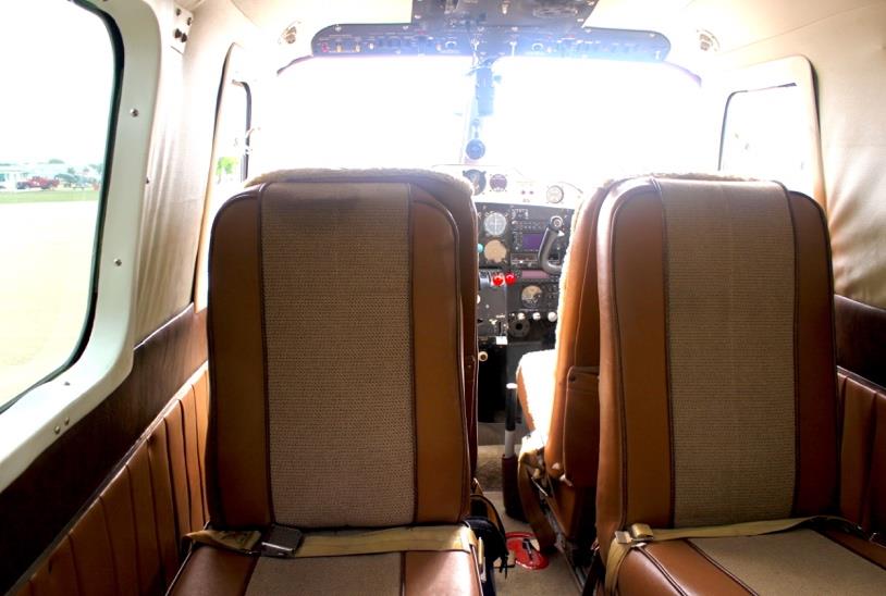 1959 Aero Commander 500A N711NE cabin interior front view with seats and cockpit