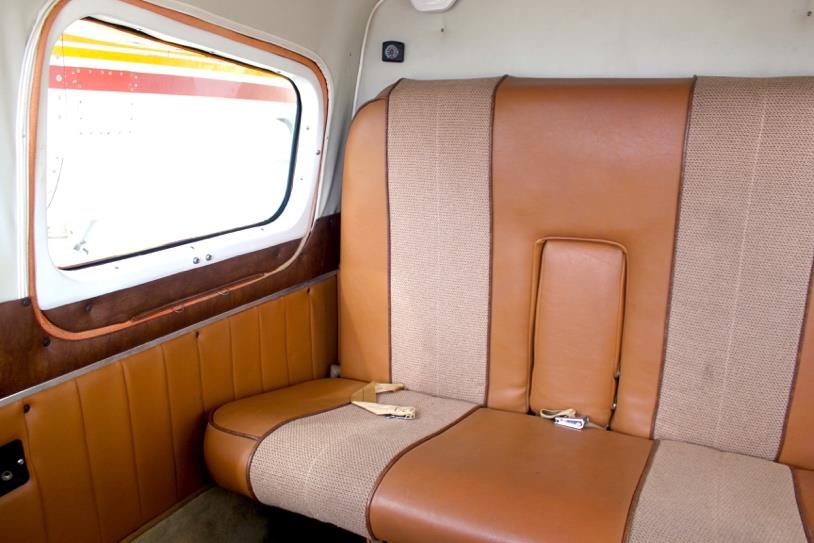 1959 Aero Commander 500A N711NE cabin interior with brown passenger seat