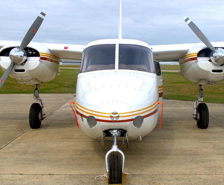 1959 Aero Commander 500A N711NE twin-engine aircraft front view on apron